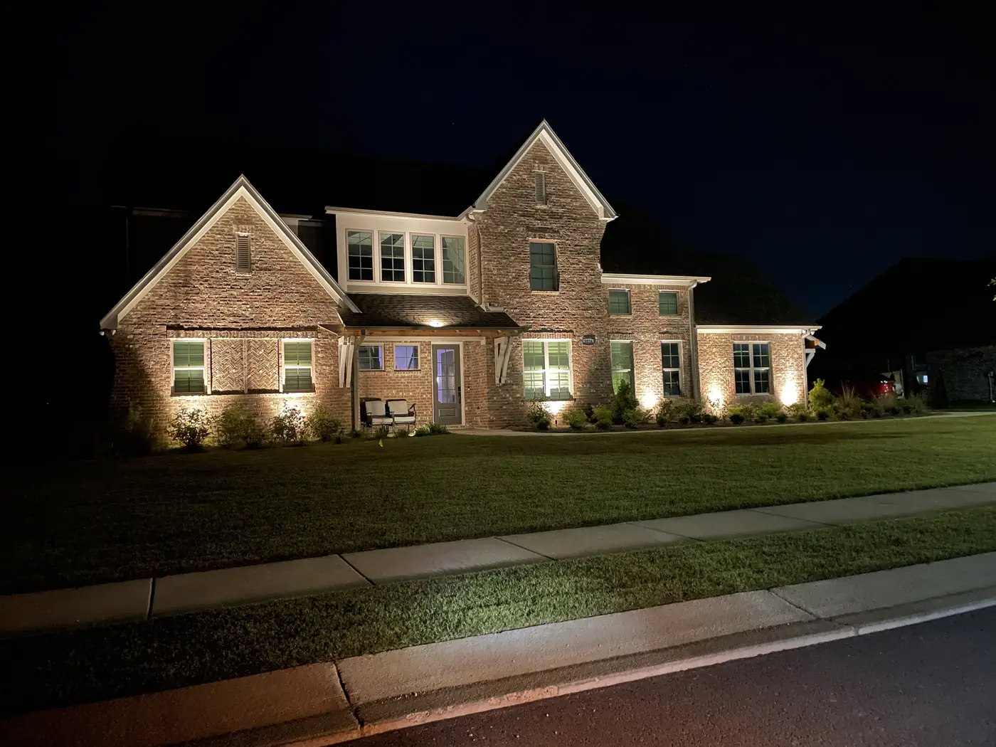 Stone brick home uplighting night Hoover Alabama