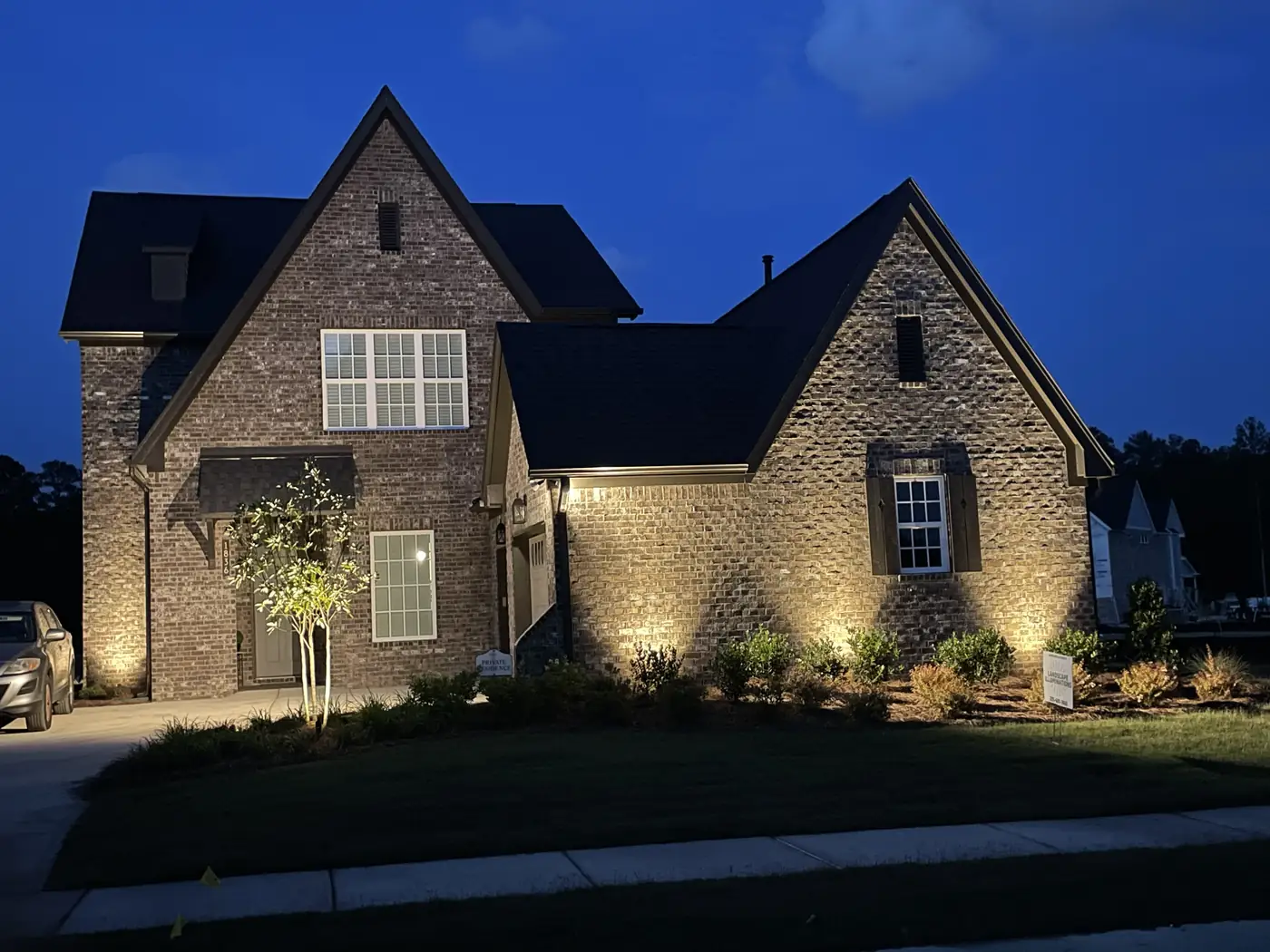 Brick home uplighting dusk Hoover Alabama