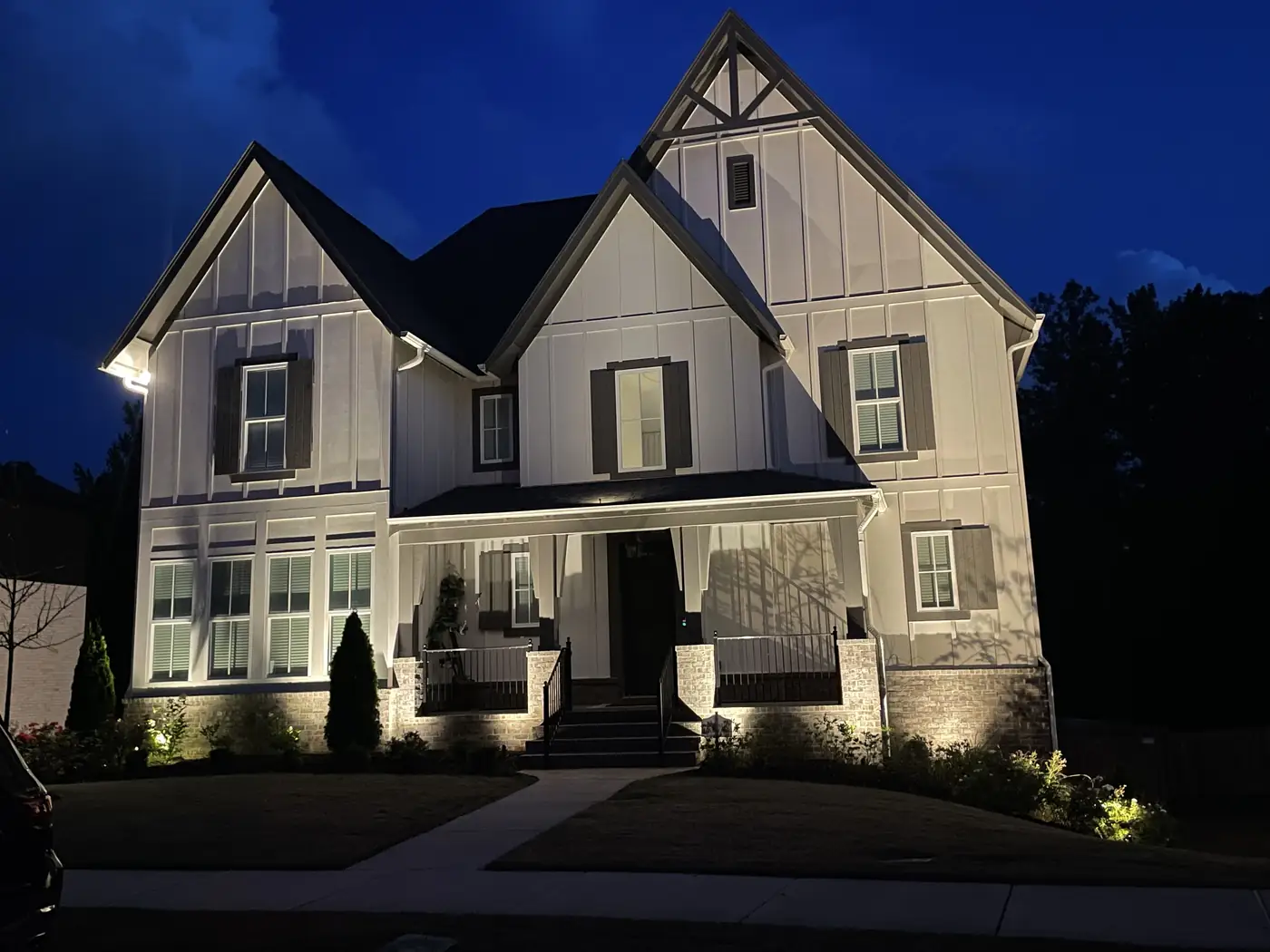 White gabled home night lighting Birmingham Alabama