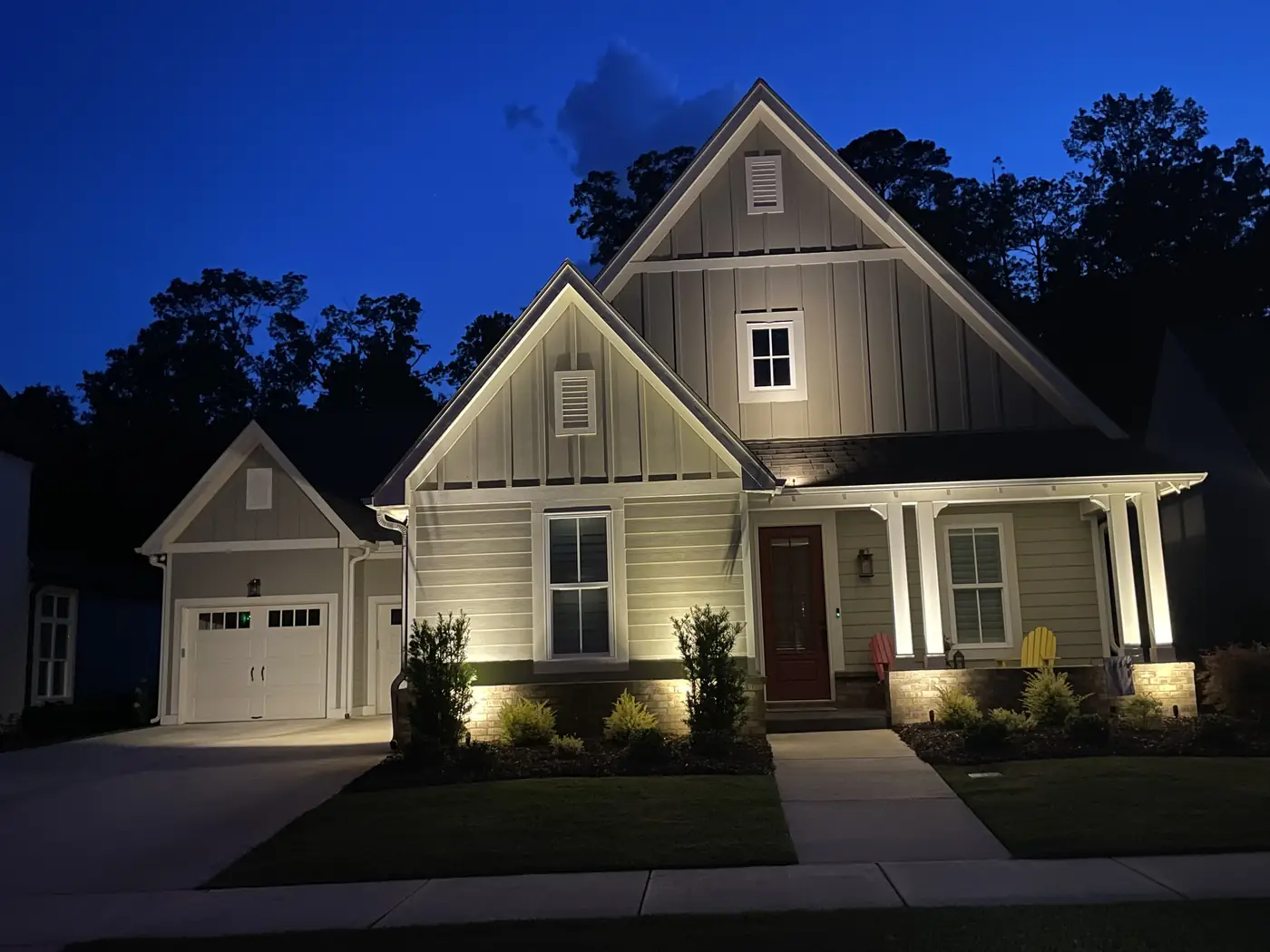 Board and batten home with red door lighting Hoover AL