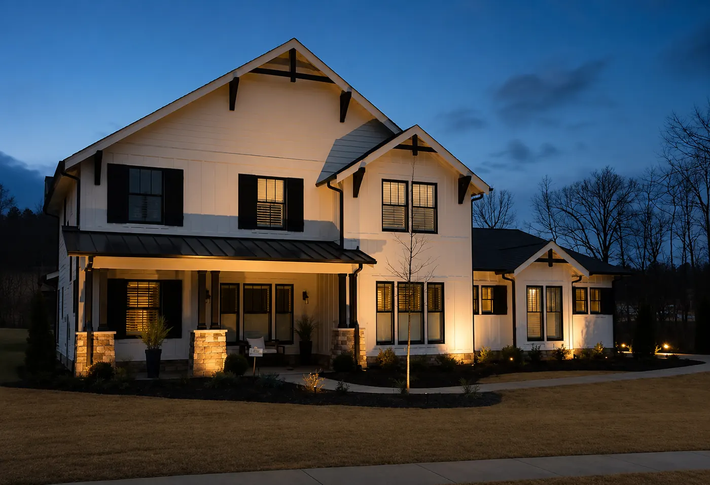White craftsman home outdoor lighting dusk Alabama